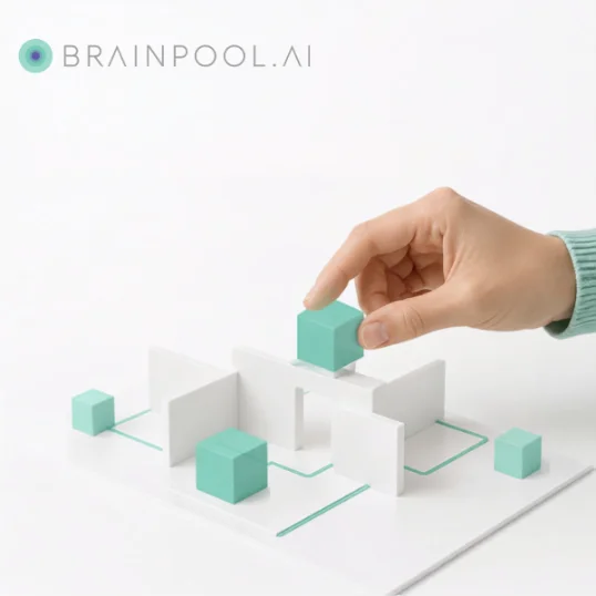 A hand placing a teal cube into an arrangement of white panels and teal blocks joined by connecting lines